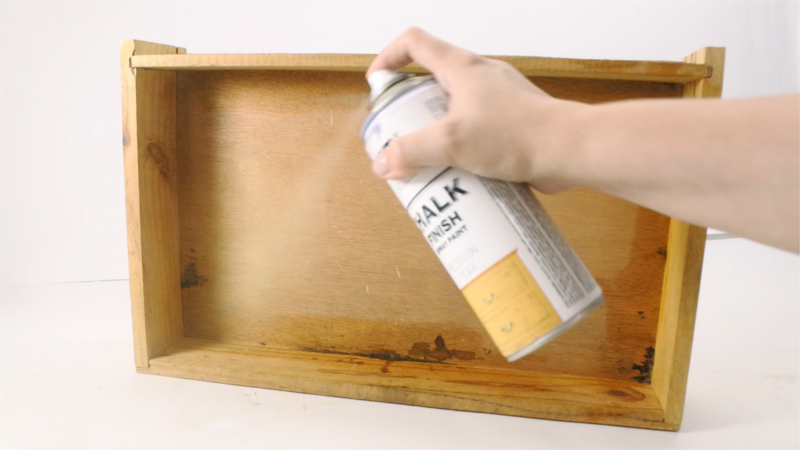 Spraying the inside of drawers with chalk paint