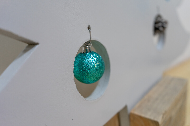 baubles hanging from MDF christmas tree